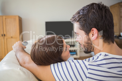 Cute couple watching tv on the couch