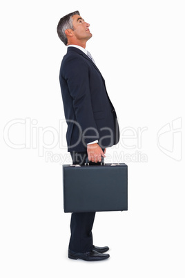 Businessman standing and holding briefcase Businessman standing and holding briefcase