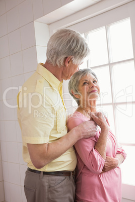 Senior couple looking out their window