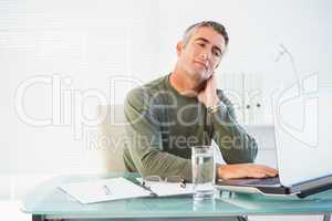 Concentrated man working with laptop