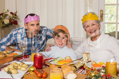 Portrait of grandmother father and son in party hat