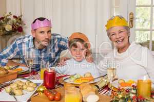 Portrait of grandmother father and son in party hat