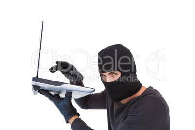 Focused burglar hacking into laptop