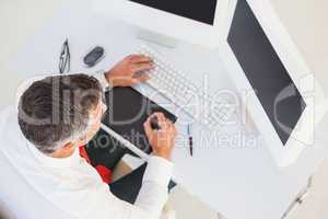 Businessman using digital tablet and computer