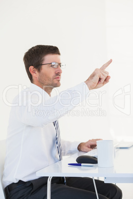 Businessman pointing at hs desk