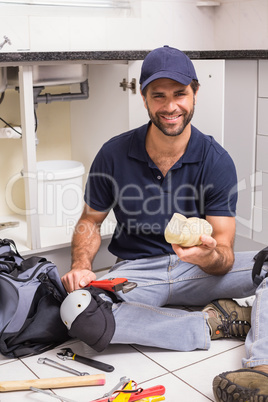 Plumber fixing under the sink