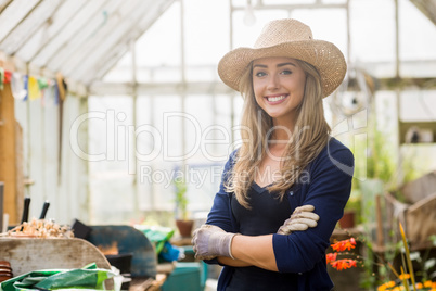 Pretty blonde smiling in greenhouse