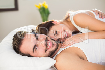 Young couple cuddling in bed