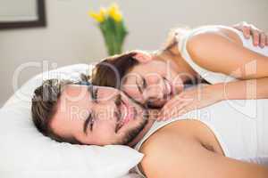 Young couple cuddling in bed