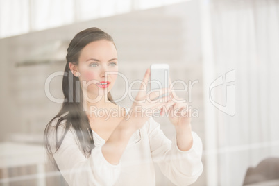 Pretty brunette taking photo on her phone