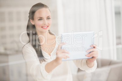 Pretty brunette using her tablet