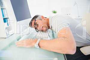 Man with glasses sleeping on the keyboard