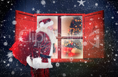 Composite image of santa claus carrying sack