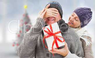 Composite image of mature woman surprising partner with gift