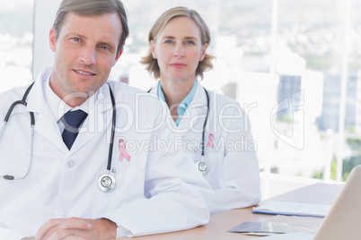 Composite image of group of doctors posing at their desk