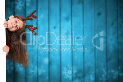 Composite image of festive little girl showing card