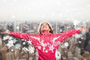 Composite image of cute girl in winter clothes with arms out