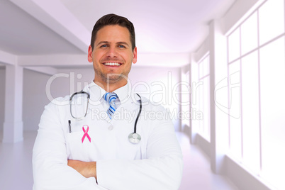Composite image of handsome doctor with arms crossed Composite image of handsome doctor with arms crossed