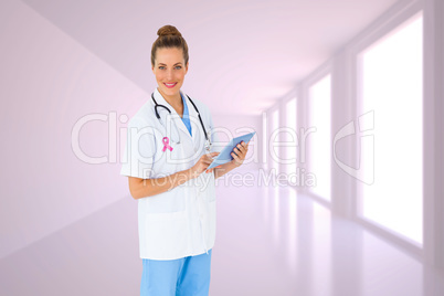 Composite image of pretty nurse using tablet pc