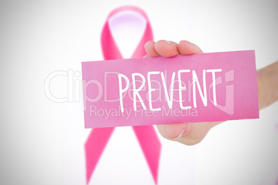 Composite image of young woman holding pink card