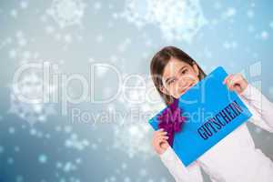 Composite image of cute little girl showing card