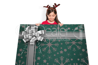 Composite image of festive little girl showing card