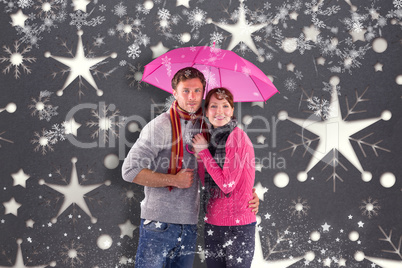 Composite image of couple standing underneath an umbrella