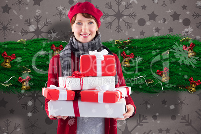 Composite image of smiling woman holding large presents