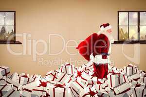 Composite image of santa walking on pile of gifts
