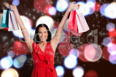 Composite image of woman standing with shopping bags