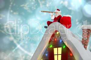 Composite image of santa sitting on roof of cottage