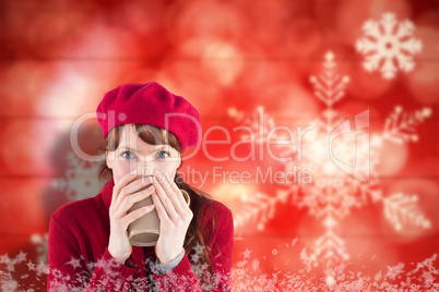 Composite image of woman drinking from a cup