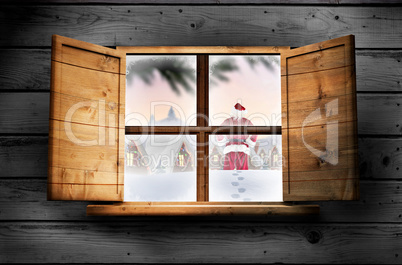 Composite image of santa delivery presents to village