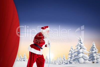 Composite image of santa claus pulling rope