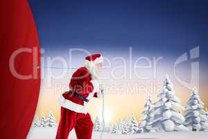 Composite image of santa claus pulling rope