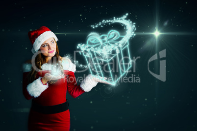 Composite image of pretty girl in santa costume holding hand out