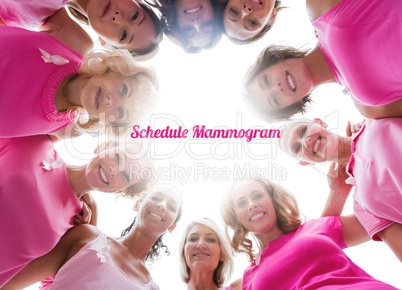 Cheerful women smiling in circle wearing pink for breast cancer