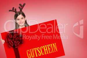 Composite image of festive little girl showing card