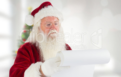 Composite image of santa claus checking his list