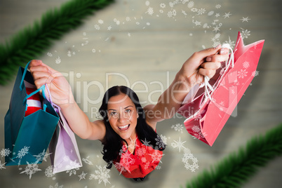 Composite image of woman standing with shopping bags