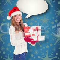 Composite image of festive blonde holding pile of gifts