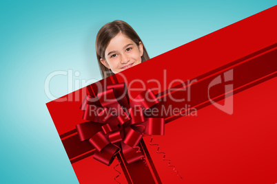 Cute girl showing card with christmas ribbon