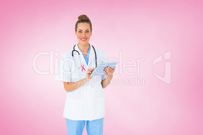 Composite image of pretty nurse using tablet pc