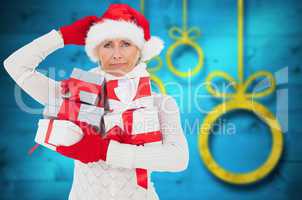 Composite image of festive woman holding gifts