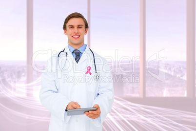 Composite image of young doctor using tablet pc