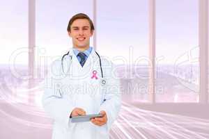 Composite image of young doctor using tablet pc