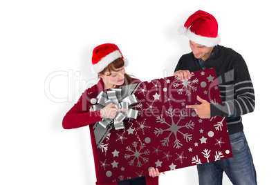 Composite image of couple holding a white sign