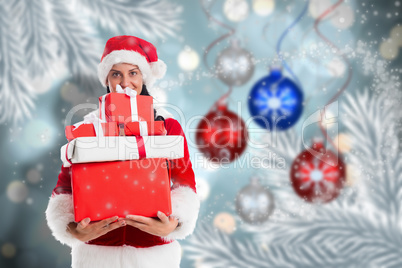 Composite image of woman smiling with christmas presents