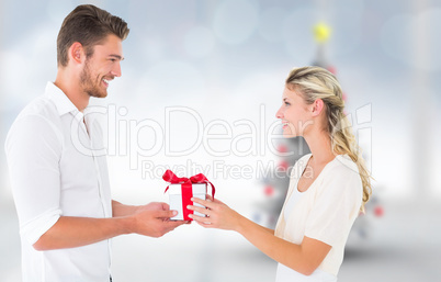 Composite image of young couple with gift