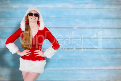 Composite image of cool santa girl wearing sunglasses